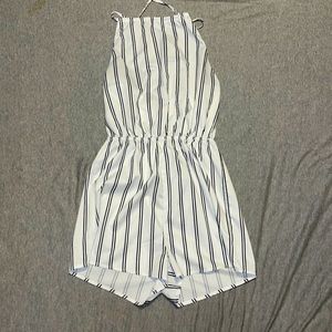 white romper with black strips and tie around neck straps